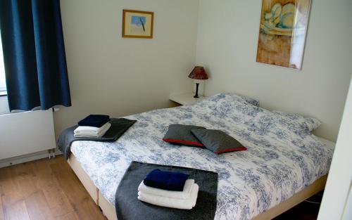 a bedroom with two beds with towels on them at De Galerie - Landgoed Rijckholt in Geersdijk