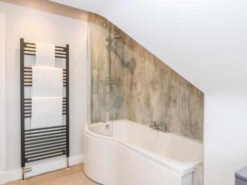 a bathroom with a bath tub and a shower at Gairnlea House in Ballater