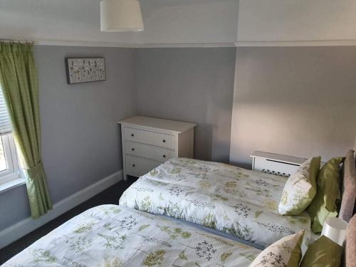 a bedroom with a bed and a dresser at Seahouses cottage in Seahouses