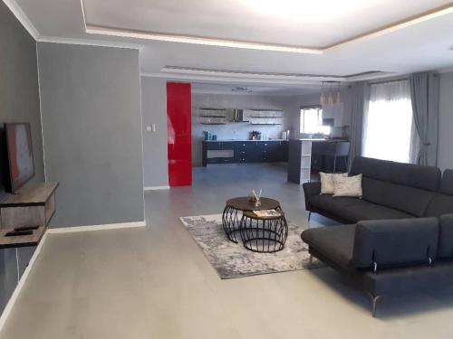 a living room with a couch and a table at Villa 13 Maun in Maun