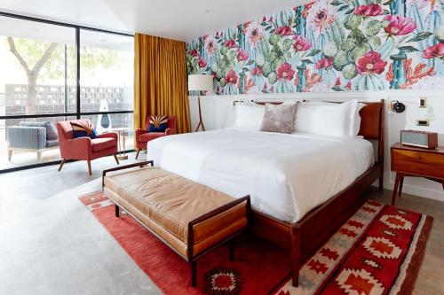 a bedroom with a large bed with a floral wallpaper at RISE Uptown in Phoenix