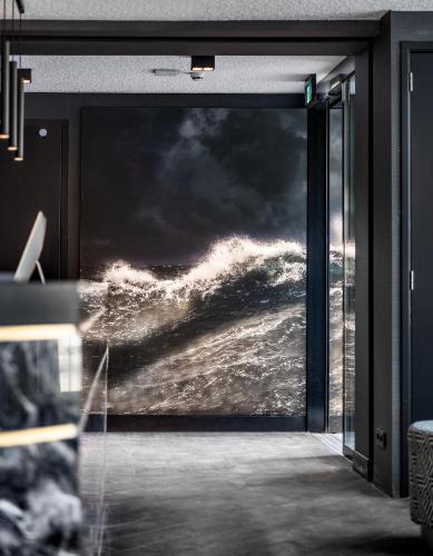 a door with a picture of the ocean on it at Le Marin Hotel Rotterdam City - Handwritten Collection in Rotterdam