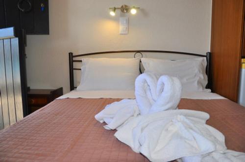 a bed with towels on top of it at Coral Front Beach in Káto Zákros