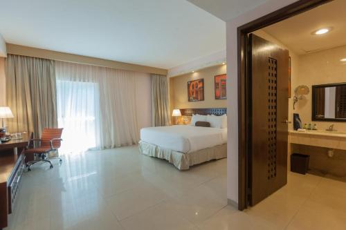 Una cama o camas en una habitación de Wyndham Merida