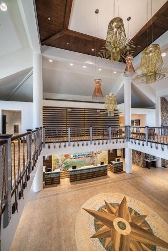 a large lobby with a staircase and a large rug at Margaritaville Vacation Club - St Thomas in Frydendal