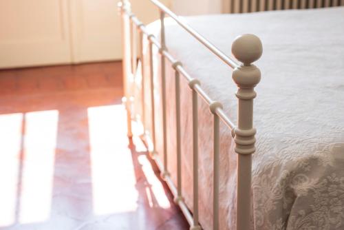 a close up of a bed with a metal railing at Fattoria Pian Di Rocca in Castiglione della Pescaia