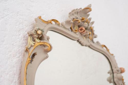 a mirror attached to a white wall with a dragon on it at Fattoria Pian Di Rocca in Castiglione della Pescaia