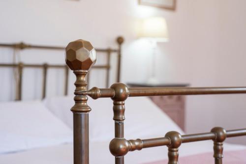 a close up of a metal rail in front of a bed at Fattoria Pian Di Rocca in Castiglione della Pescaia