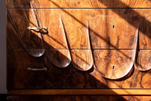 a wooden dresser with pairs of shoes on it at Fattoria Pian Di Rocca in Castiglione della Pescaia