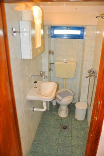 a small bathroom with a toilet and a sink at Beachfront Apartment Kato Zakros in Káto Zákros
