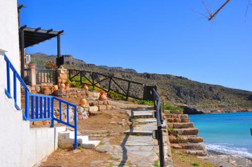 a stairway leading up to a building next to the ocean at Beach Front Kato Zakros in Káto Zákros