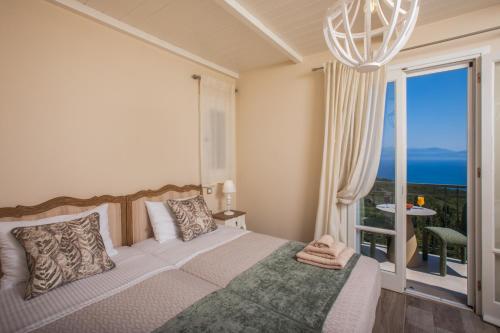 a bedroom with a bed and a large window at Luxury villa above emblisi beach , with heated pool ! in Fiskardho