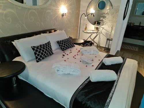 a white bed with red confetti on top of it at אחוזת שקד in Mishmār Hāyardin