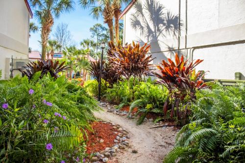a garden with colorful plants and palm trees at Bryan's Spanish Cove in Orlando