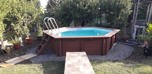 a hot tub in a yard with aitating at La Roulotte De Tina in Le Moule