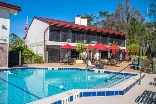a house with a swimming pool and a patio at Bryan's Spanish Cove in Orlando