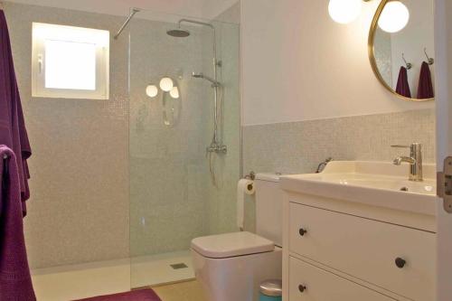 a bathroom with a shower and a toilet and a sink at Magallanes Apartment in Cala Ratjada
