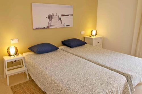 two beds sitting next to each other in a bedroom at Magallanes Apartment in Cala Ratjada