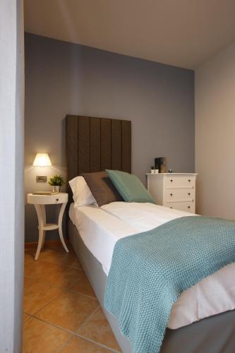 a bedroom with a large bed and a table at Hotel Milano & Apartments in Miazzina