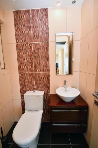 a bathroom with a toilet and a sink at Villa Blue Dream in Koutsounari