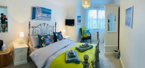 a bedroom with a bed with two towels on it at Stunning Seafront House with garden and private parking in Eastbourne
