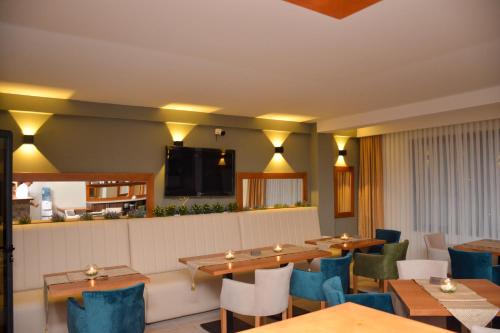 a restaurant with wooden tables and blue chairs at AM Palace in Ulcinj