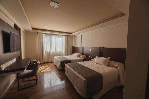 Postel nebo postele na pokoji v ubytování Hotel Sirari By Regina