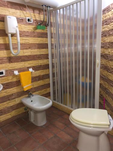 a bathroom with a toilet and a shower at Oasi Bochini in Avola