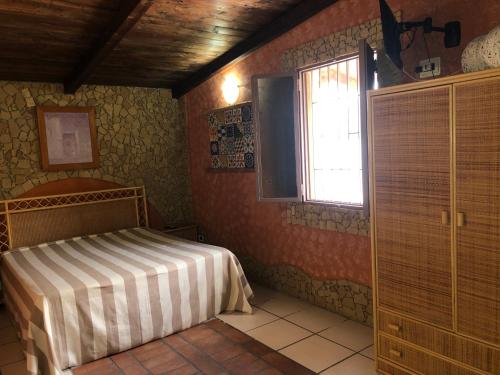 a bedroom with a bed and a window at Oasi Bochini in Avola