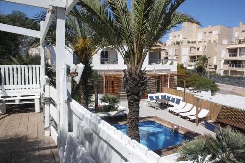 un balcón con una palmera y una piscina en Pipe- SweethomeRooms Cabo de Palos, en Cabo de Palos