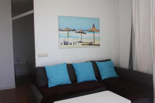 uma sala de estar com um sofá e uma pintura na parede em Galua- SweethomeRooms Cabo de Palos em Cabo de Palos