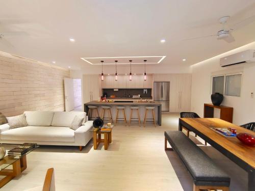 a living room with a couch and a table at 1st Luxury Warehouse in Cancún