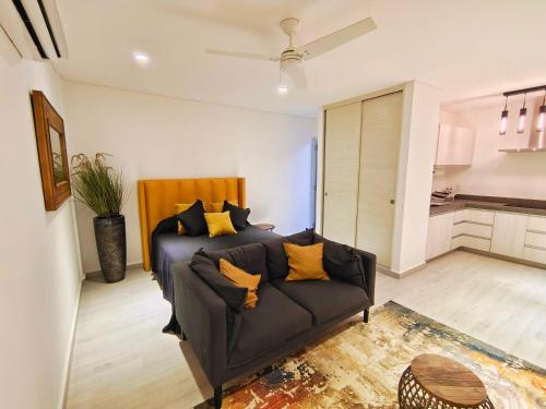 a living room with a couch with yellow pillows at 1st Luxury Warehouse in Cancún