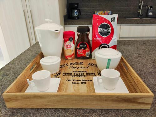 a wooden tray with three cups and a mixer at 1st Luxury Warehouse in Cancún
