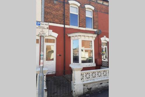 a street sign in front of a brick building at Seaside Home from Home 4bedroom sleeps 8 in Bridlington