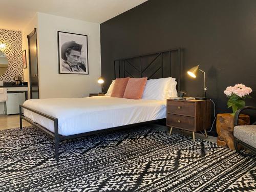 a bedroom with a large bed and a table with a night stand at Wimberley Inn & bar in Wimberley