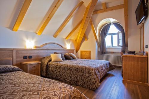 Postel nebo postele na pokoji v ubytování Hotel Vittoria