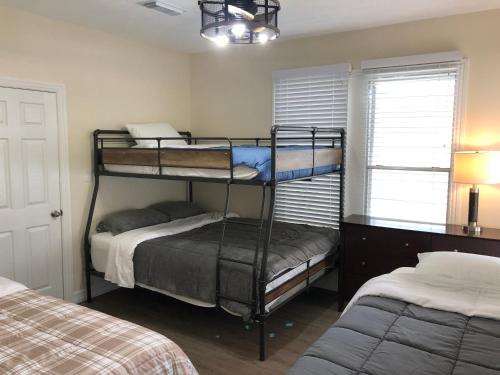 a bedroom with two bunk beds and a window at Seaside Cottage in Galveston