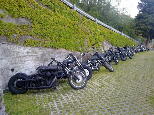 a row of motorcycles parked next to a stone wall at Albergo Deva in Riva del Garda
