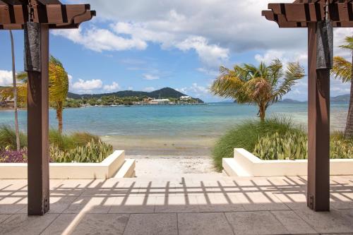 a view of a beach with palm trees and the ocean at Margaritaville Vacation Club - St Thomas in Frydendal