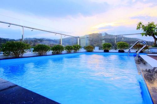 a swimming pool on the roof of a building at Nếp Apartment Hotel in Vung Tau