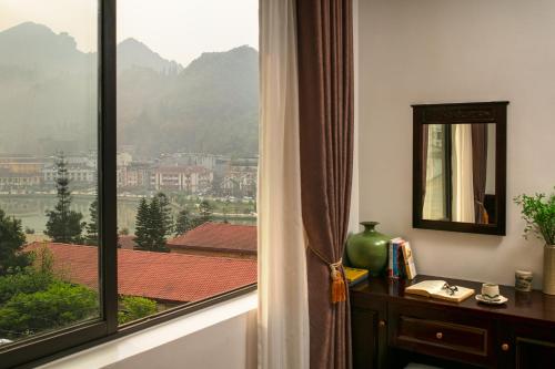 a room with a window with a view of a city at Sapa Mountain Queen House in Sapa