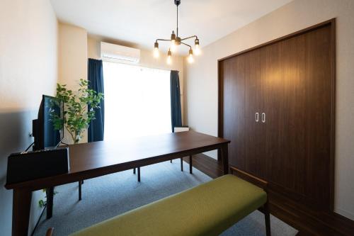 an office with a desk and a sliding door at Hotel Piacere NAMBA in Osaka