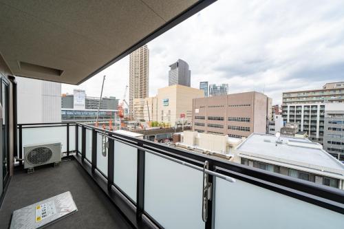 a balcony with a view of a city skyline at Hotel Piacere NAMBA in Osaka