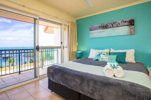 a bedroom with a bed with a view of the ocean at Tropical Oasis, Million Dollar Views, 2 Pools in Cannonvale