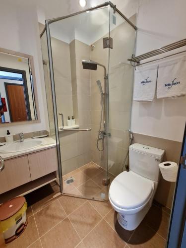 a bathroom with a shower and a toilet and a sink at Ngan Hoa - Mille Fleurs in Da Lat