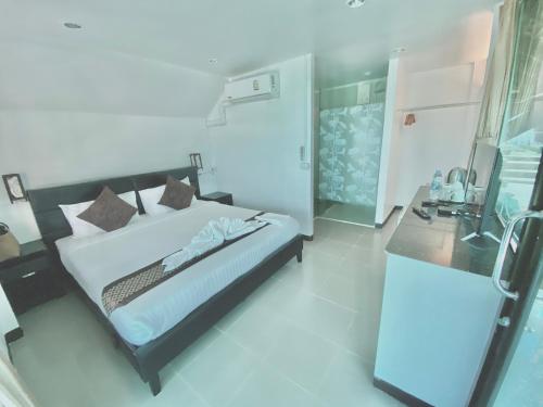 a bedroom with a bed and a desk in it at The Shore Samui in Bang Rak Beach