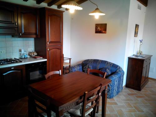 a kitchen and dining room with a table and a couch at Agriturismo Collomici in Celle sul Rigo