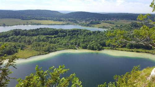 an aerial view of a lake in the woods at Sancier gîte au calme grand terrain circuit cascades du Hérisson in Saugeot