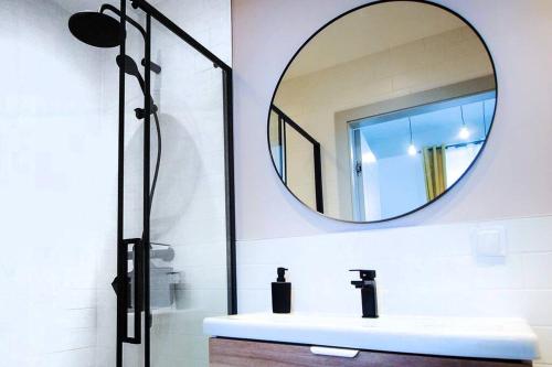 a bathroom with a sink and a mirror at Gliwice on a budget 90m from the main square in Gliwice